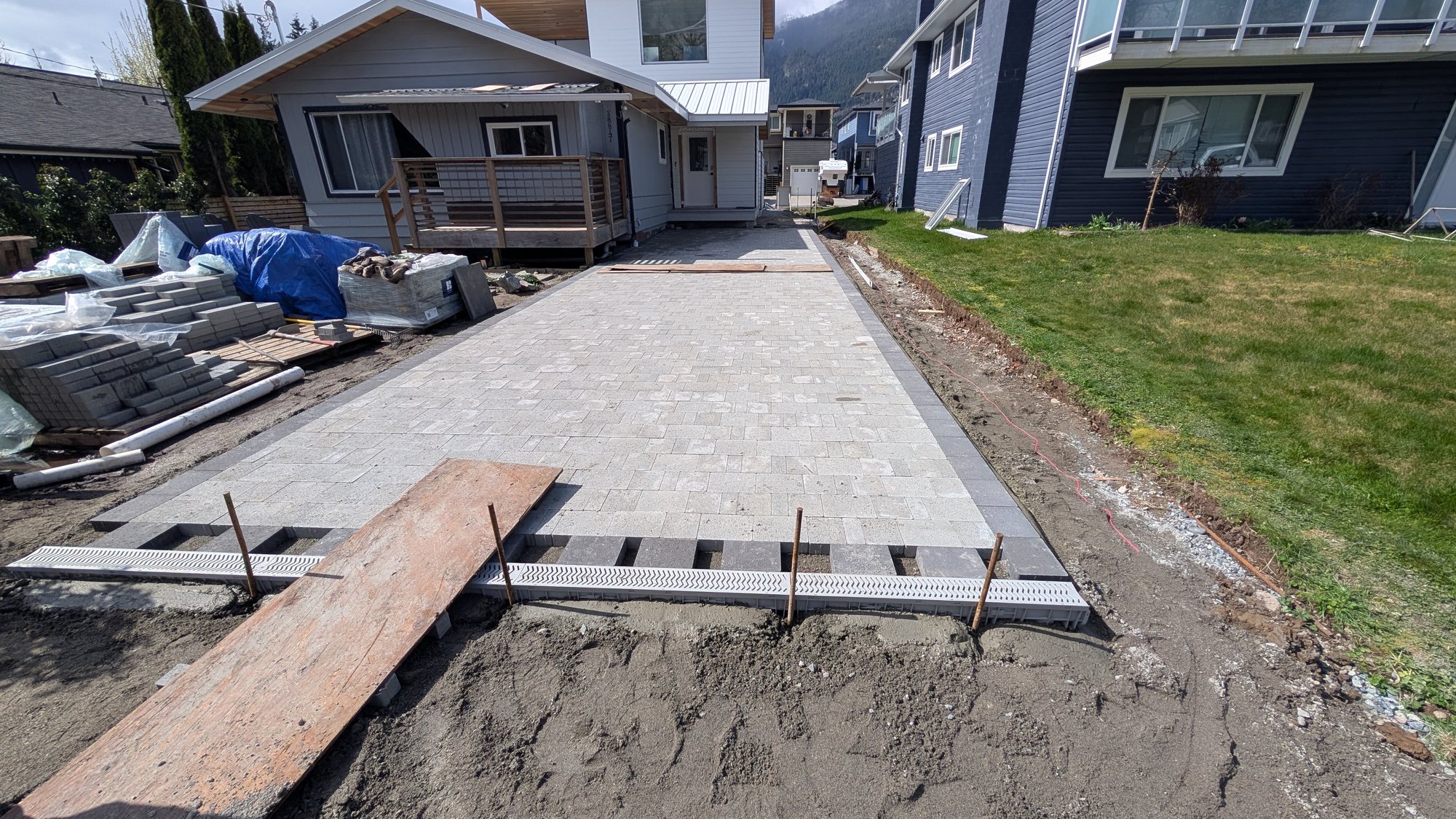 New paver driveway installation with an integrated linear drain channel